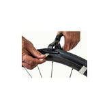 Vittoria Air-Liner tool with pliers and clips for tubeless road tyre installation, showcasing components and tools in a professional setup.