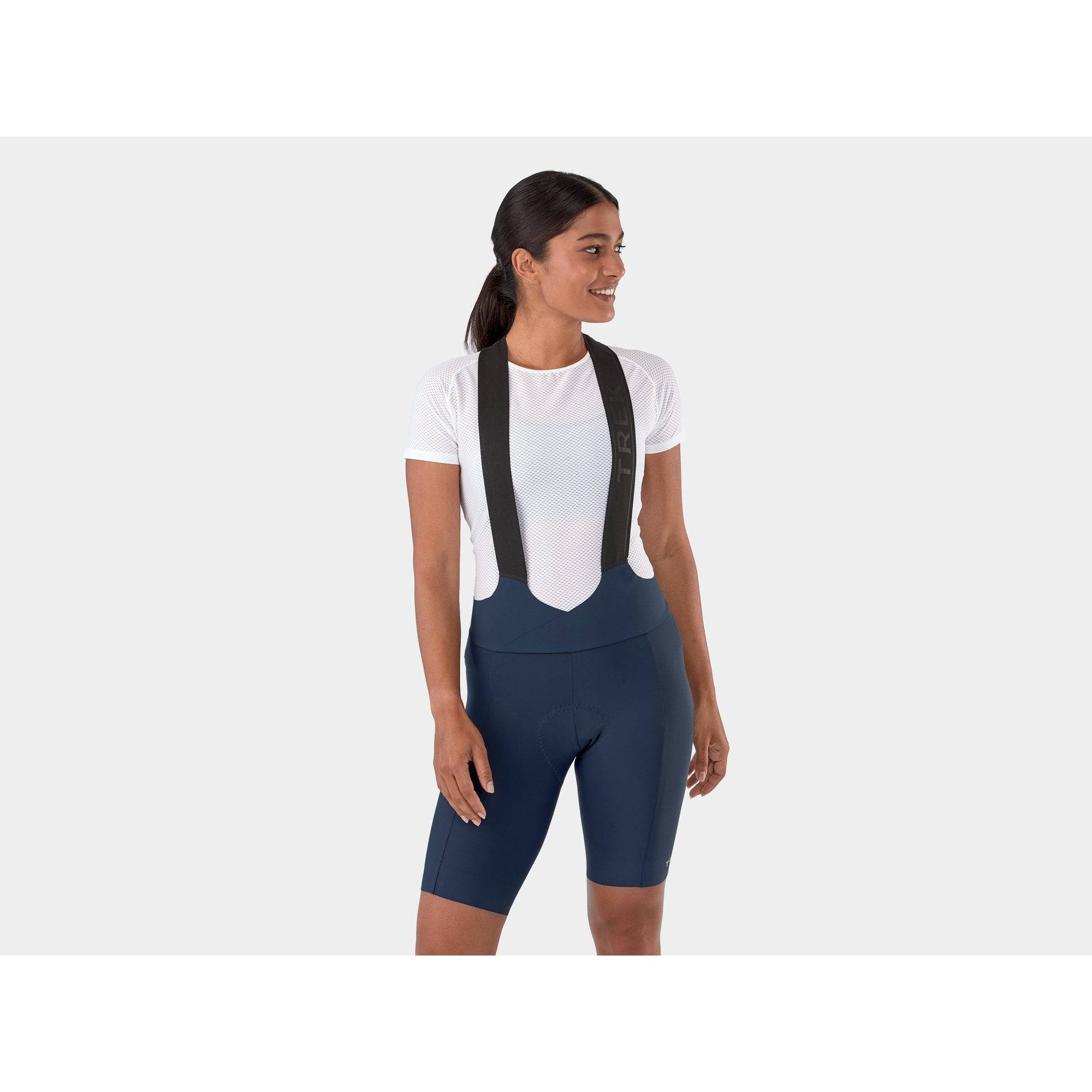 Trek Velocis Women's Cycling Bib Shorts, breathable eco-friendly performance clothing, shown on a model for comfortable riding.