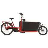 Trek Fetch+ 4 electric cargo bike with Bosch Performance Line CX motor and customizable child seating in a city setting.