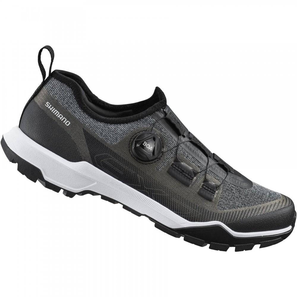 Shimano EX7 black MTB shoes with BOA L6 dial and ULTREAD EX outsole, designed for mountain biking, shown in a product image.