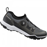 Shimano EX7 black MTB shoes with BOA L6 dial and ULTREAD EX outsole, designed for mountain biking, shown in a product image.