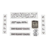 Surly bike decal kit with headbadges, frame decals, and spare components for customizing bicycle appearance.