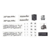 Surly 5 port hose and gear spares kit with headbadge for bike components, featuring hoses, fittings, and branding details.