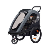 Hamax Avenida One child bike trailer and stroller, blue, with safety harness and storage area, designed for toddler transportation.