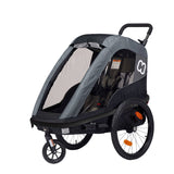 Hamax Avenida One child bike trailer and stroller in red with safety harness and large wheels for toddler transport.