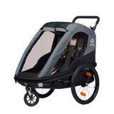 Hamax Avenida Twin child bike trailer and stroller with suspension and safety features, designed for family outdoor activities.
