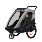 Hamax Avenida Twin child bike trailer and stroller with suspension and safety features, designed for family outdoor activities.