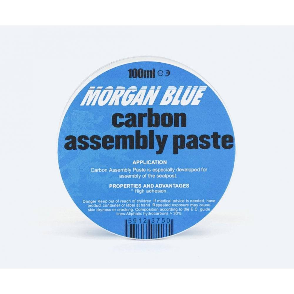 Morgan Blue Carbon Assembly Paste tub, a lubricant for carbon and aluminium bike parts, shown in a workshop setting.