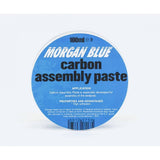 Morgan Blue Carbon Assembly Paste tub, a lubricant for carbon and aluminium bike parts, shown in a workshop setting.