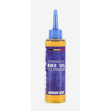 Morgan Blue bike oil lubrication for touring and city bike chains and drivetrains, used in workshop maintenance.