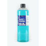 Morgan Blue Bike Wash cleaner in a workshop setting, showing a bottle of gentle bike soap for cleaning and protecting bicycles.