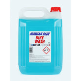 Morgan Blue Bike Wash cleaner in a workshop setting, showing a container of gentle bike soap for cleaning and protecting bicycles.