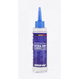 Morgan Blue Extra Dry Lube spray for MTB and cyclocross bike chains, shown in workshop setting.