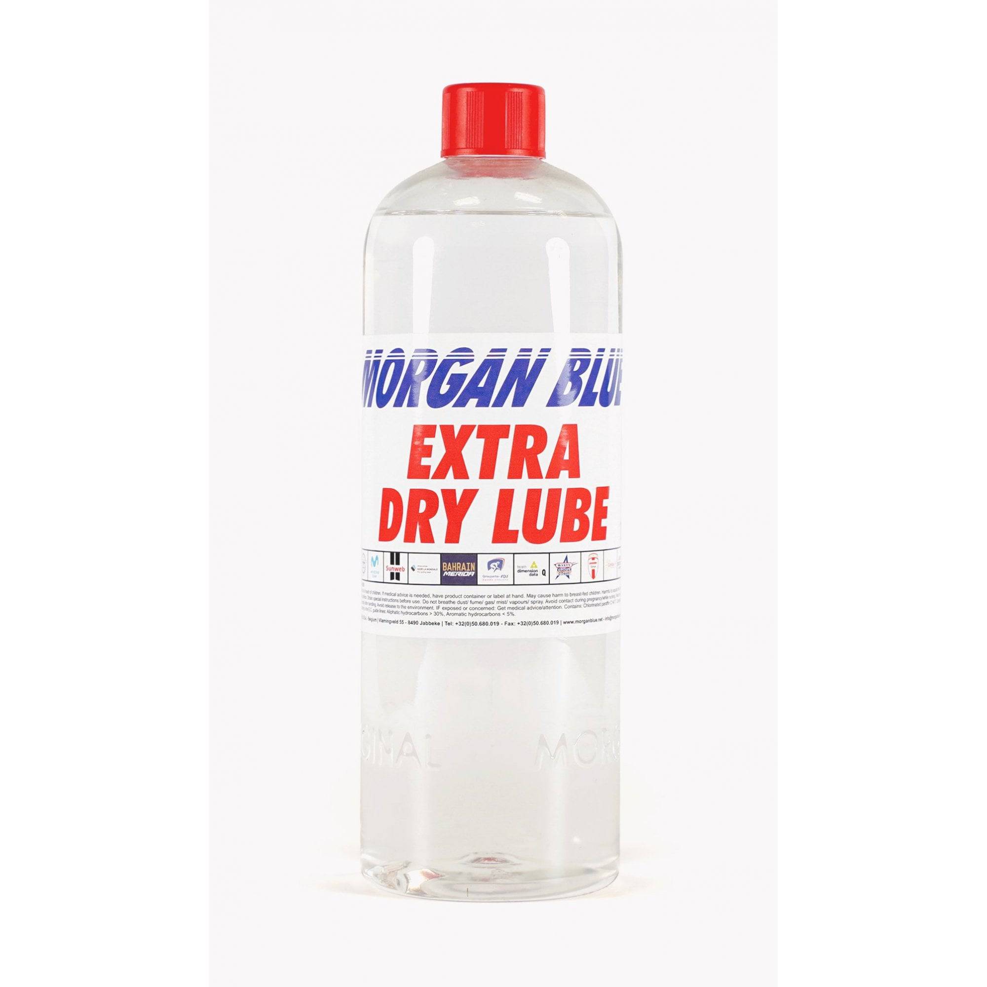 Morgan Blue Extra Dry Lube MTB and cyclocross bike chain lubrication spray shown in a workshop setting.