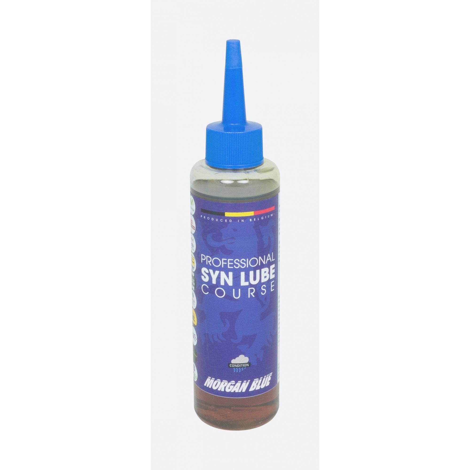 Morgan Blue Syn Lube Course synthetic chain oil bottle for road cycling, featuring a workshop setting with cycling tools.