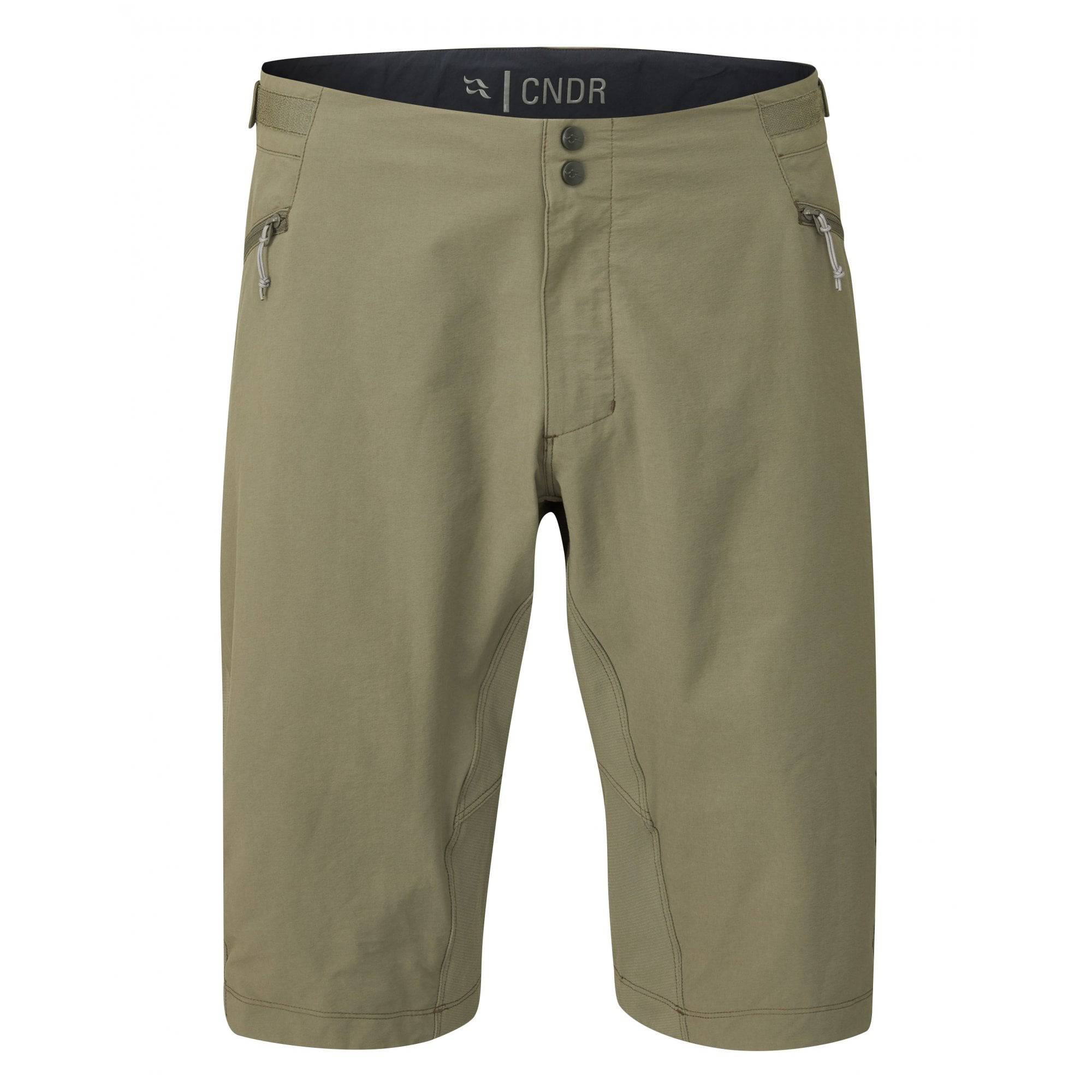 Rab Cinder Crank cycling shorts with adjustable waist, ventilation zips, and pockets, shown on a model for outdoor cycling.