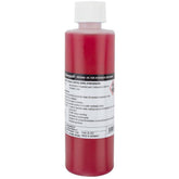 Campagnolo Mineral Oil Brake Fluid for hydraulic disc brake systems, shown in a workshop setting with bottles and tools.