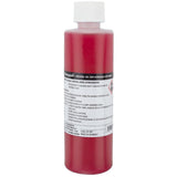 Campagnolo Mineral Oil Brake Fluid for hydraulic disc brake systems, shown in a workshop setting with bottles and tools.