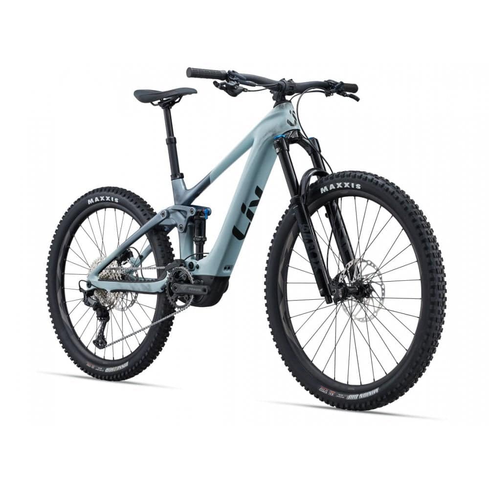 Liv Intrigue X Advanced E+ EL 2 women's electric mountain bike with SyncDrive Pro motor, black frame and rugged tires.