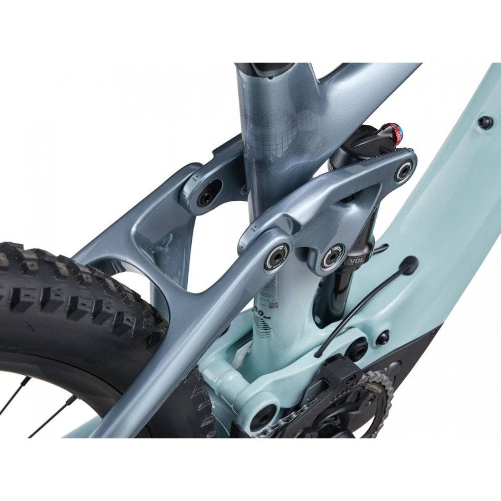 Liv Intrigue X Advanced E+ EL 2 women’s electric mountain bike with SyncDrive Pro motor and 25km/h speed, shown on trail.