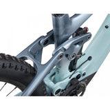 Liv Intrigue X Advanced E+ EL 2 women’s electric mountain bike with SyncDrive Pro motor and 25km/h speed, shown on trail.