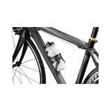 Topeak Shuttle Cage Black water bottle holder mounted on a bicycle frame, featuring durable construction and easy mounting system.