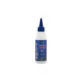 Squirt SEAL Tyre Sealant with BeadBlock for puncture protection on tubed and tubeless wheels, shown in a workshop setting.