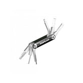 Topeak BB Hide n Tool Black compact MTB bottom bracket multi-tool with 7 functions, displayed on a workshop surface.