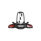 Thule VeloCompact 926021 3-bike towball carrier with 13-pin connector mounted on vehicle, showcasing its compact design and secure bike hold.