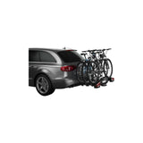 Thule VeloCompact 926021 3-bike towball carrier with 13-pin connector, shown attached to a vehicle for bike transport.