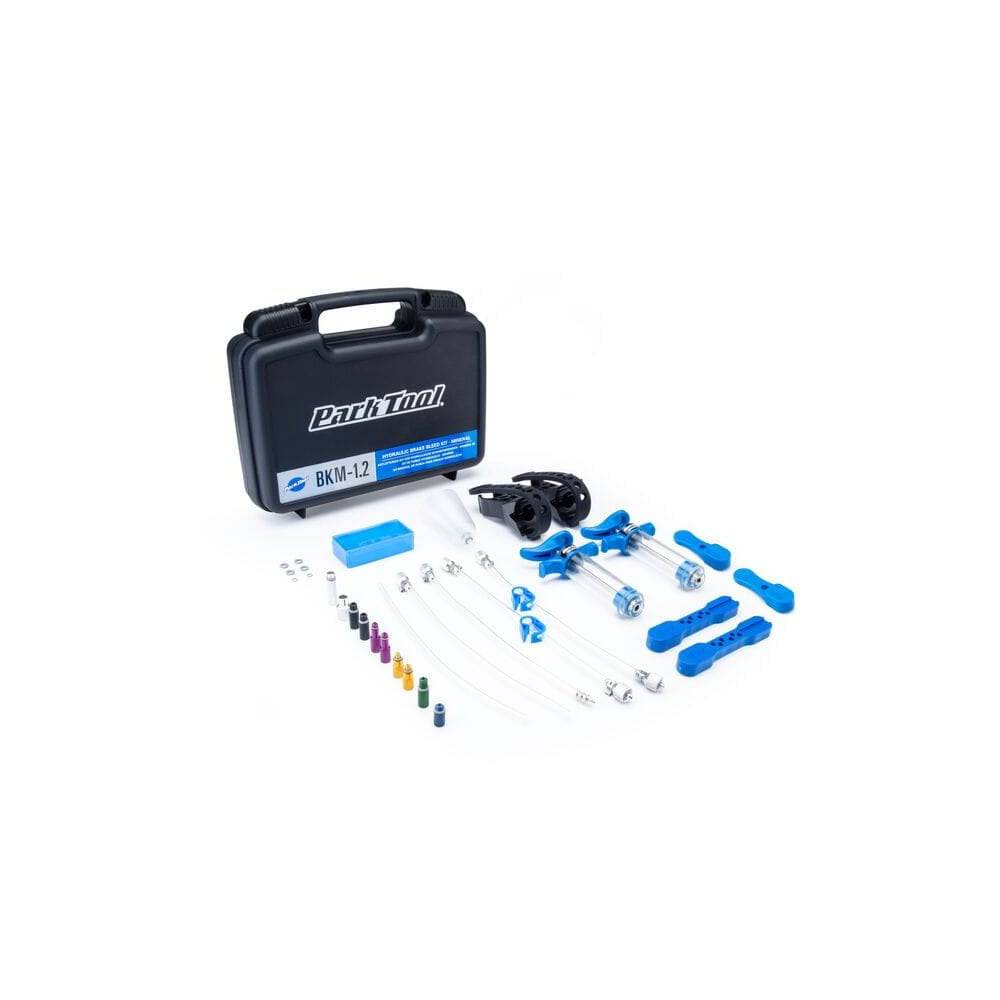 Park Tool BKM-1.2 hydraulic brake bleed kit for mineral oil disc brakes, shown with tools and components on a workshop table.