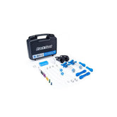 Park Tool BKM-1.2 hydraulic brake bleed kit for mineral oil disc brakes, shown with tools and components on a workshop surface.