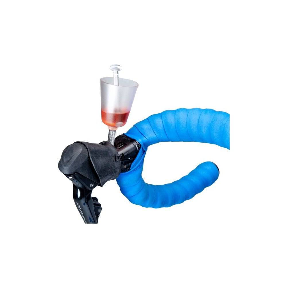 Park Tool BKM-1.2 Hydraulic Brake Bleed Kit for mineral oil disc brakes, showing tools and components in a workshop setting.