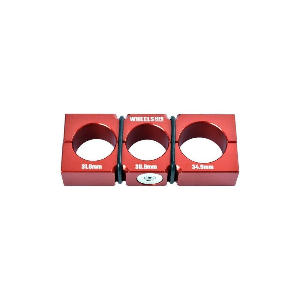 Wheels Manufacturing workshop seatpost shaft block with magnetic clamps for 30.9-34.9mm dropper seatposts, used for secure bike maintenance.