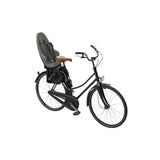 Thule Yepp 2 Maxi child bike seat with rear tube mount and safety harness, designed for secure child riding comfort.