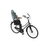 Thule Yepp 2 Maxi child bike seat rear mount with safety harness, designed for secure bike riding with young children.