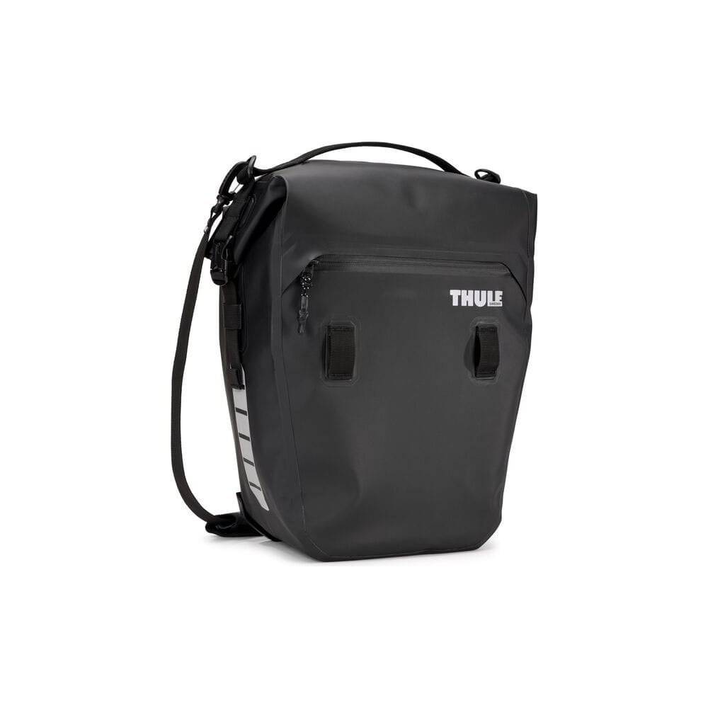 Pair of Thule Shield waterproof panniers with reflective panels, designed for touring and commuter bikes, mounted on bike racks.