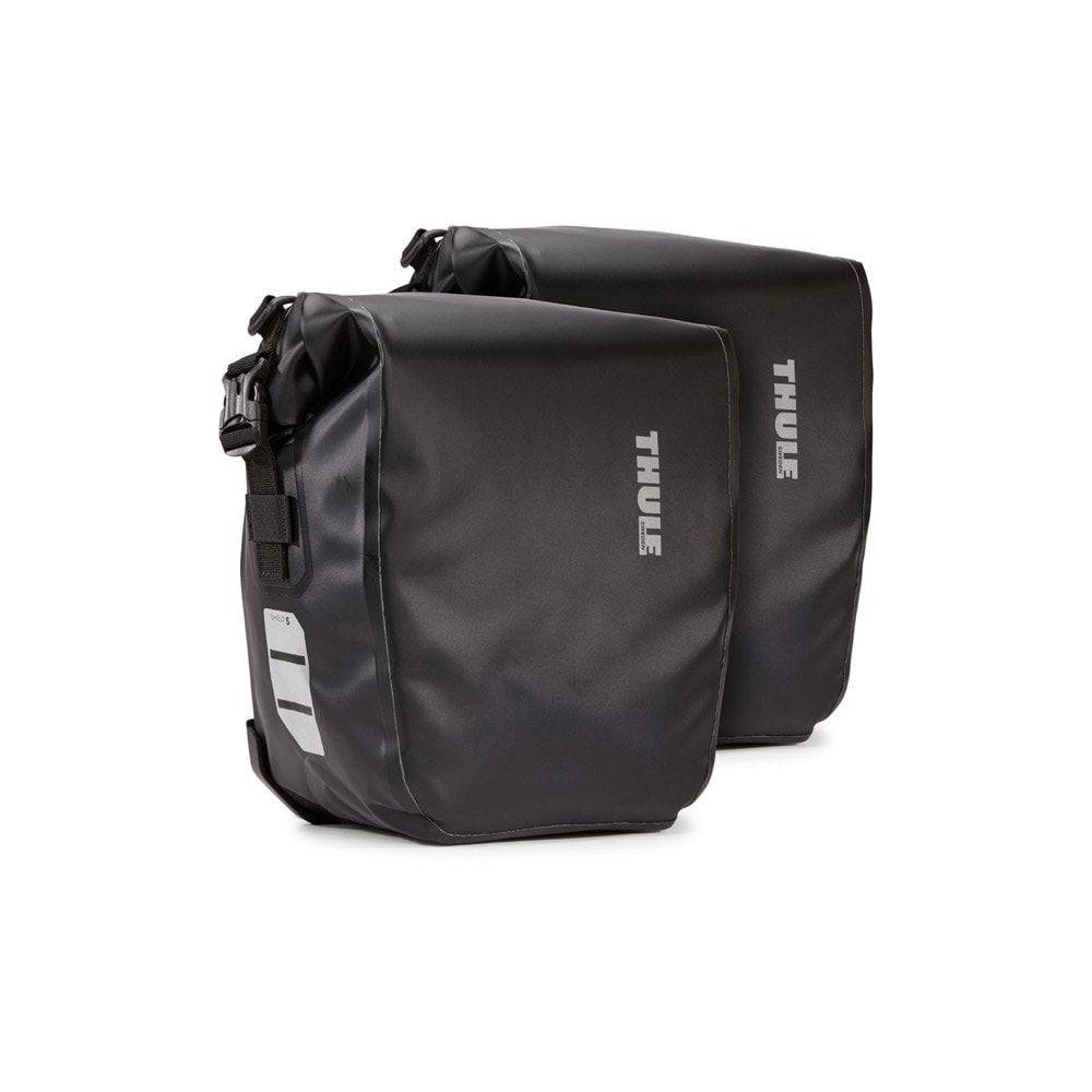 Pair of Thule Shield waterproof bike panniers with reflective panels, designed for touring and commuting cycling accessories.