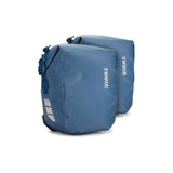 Pair of Thule Shield waterproof bike panniers with reflective panels, designed for touring and commuting, attached to a bike.