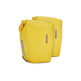 Pair of Thule Shield waterproof bike panniers with reflective panels for touring and commuting, mounted on a bike.