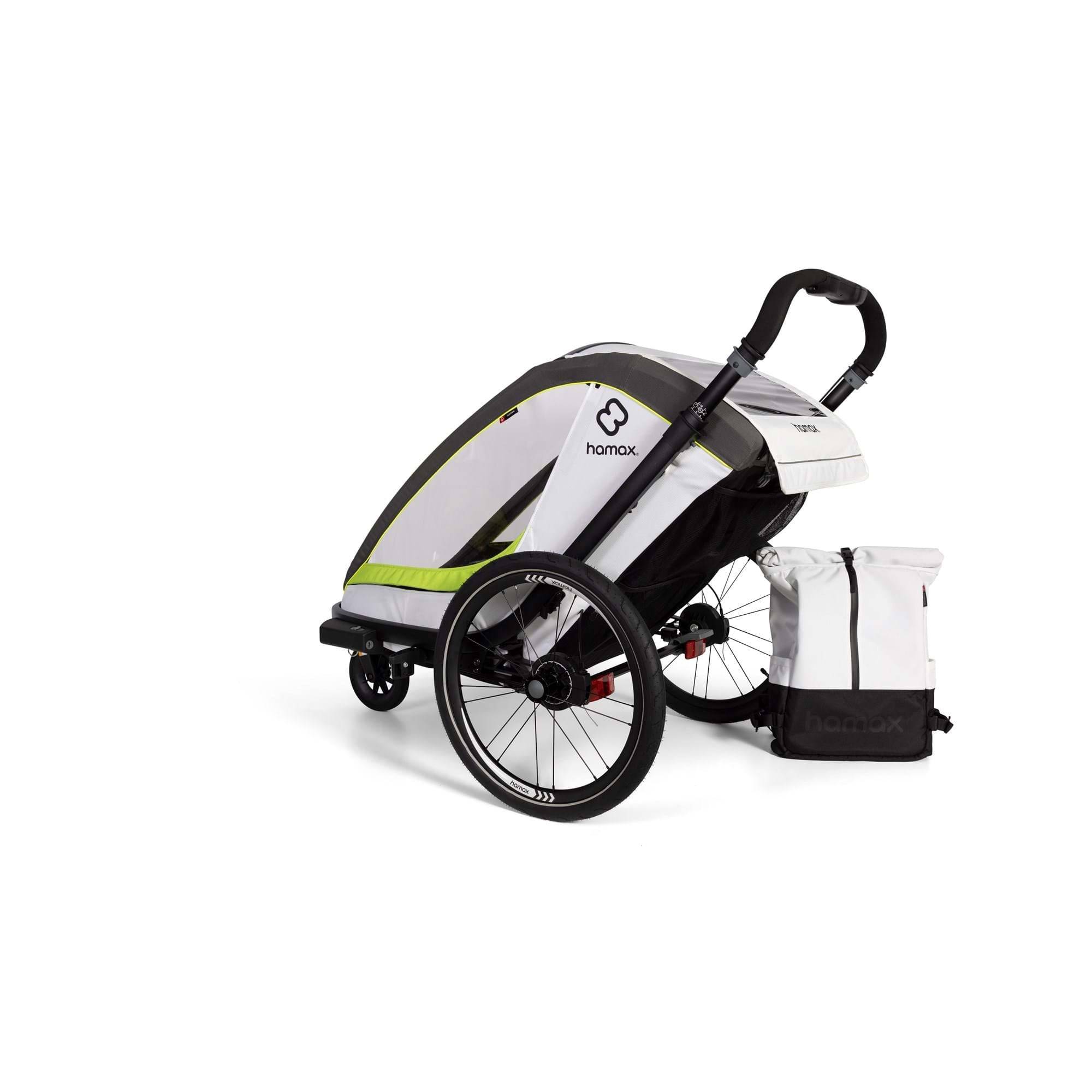 Hamax Breeze child bike trailer with stroller wheel, safety features, and durable fabric for secure family outdoor adventures.