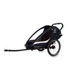 Hamax Breeze child bike trailer with stroller wheel and safety features, showing the trailer's sleek design and safety harness.