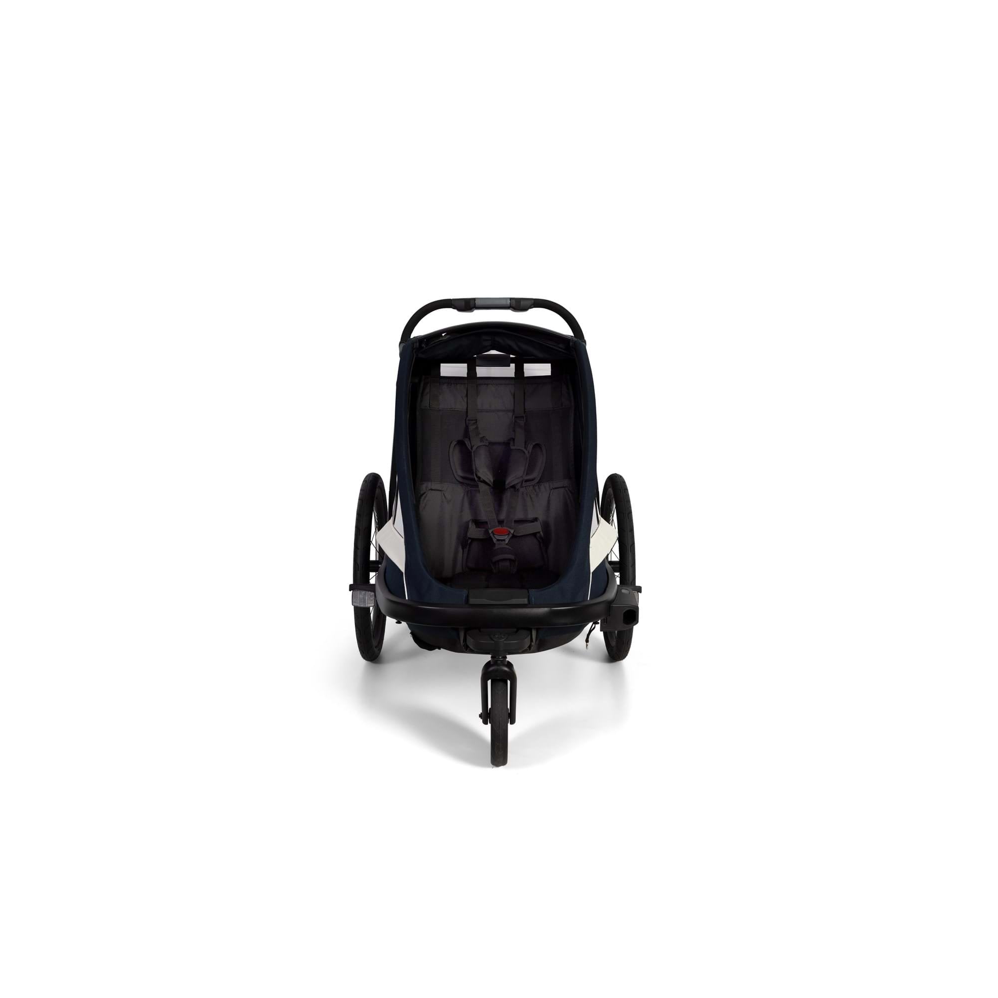 Hamax Breeze child bike trailer with stroller wheel, safety harness, and durable frame for secure family outdoor rides.