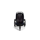Hamax Breeze child bike trailer with stroller wheel, safety harness, and durable frame for secure family outdoor rides.