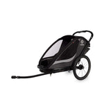 Hamax Cocoon Twin child bike trailer and stroller with brake, featuring a sleek design and convertible features for kids' outdoor activities.