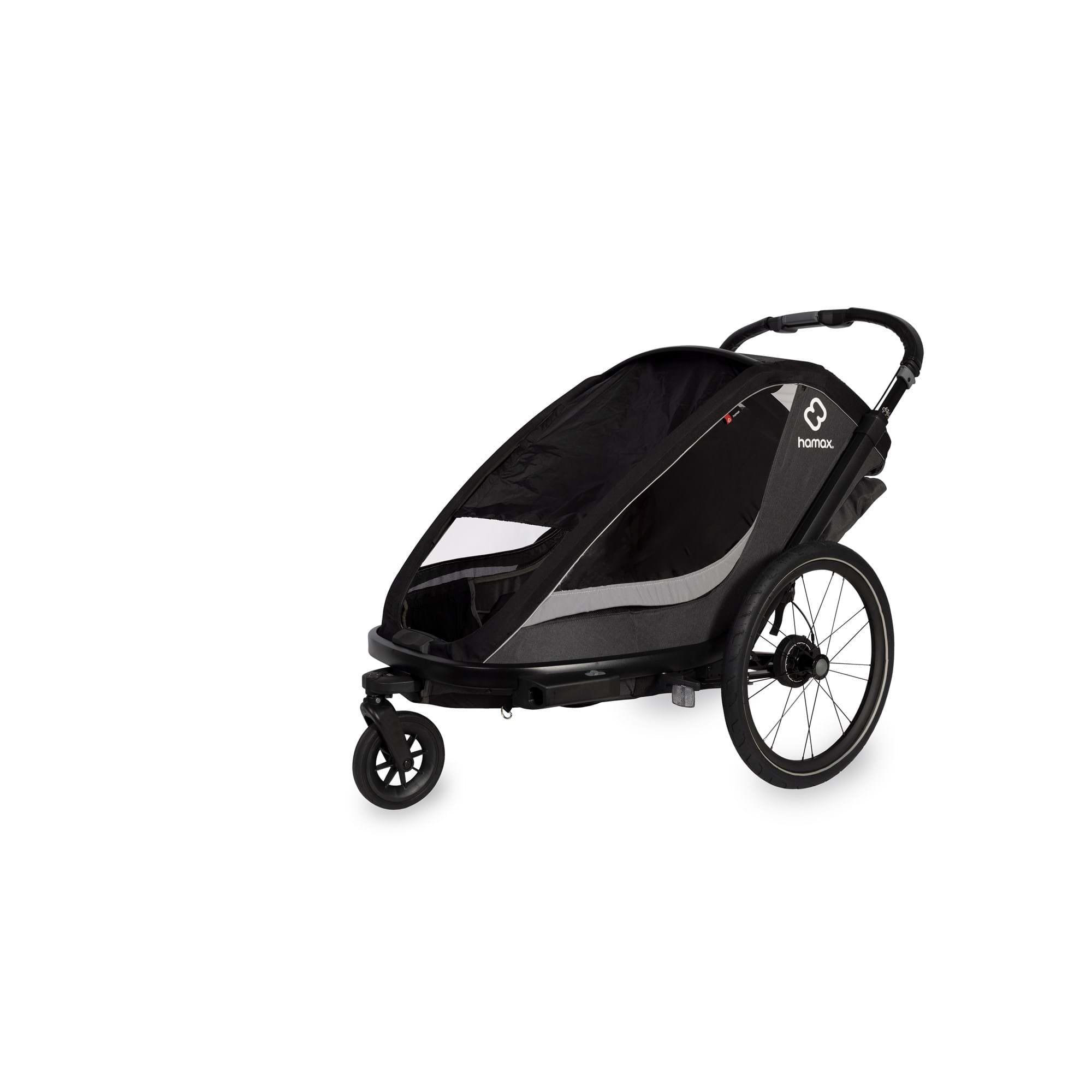 Hamax Cocoon Twin child bike trailer convertible to stroller and jogger with brake, designed for safe family outdoor activities.