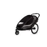 Hamax Cocoon Twin child bike trailer convertible to stroller and jogger with brake, designed for safe family outdoor activities.