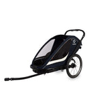 Hamax Breeze twin child bike trailer with stroller conversion, safety harnesses, and durable frame for family outdoor activities.