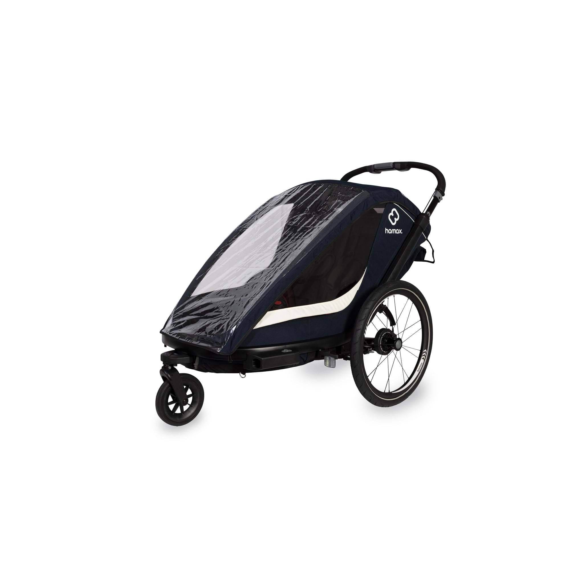 Hamax Breeze twin child bike trailer with stroller conversion, safety harnesses, and waterproof cover, designed for family outdoor activities.