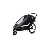 Hamax Breeze twin child bike trailer with stroller conversion, safety harnesses, and waterproof cover, designed for family outdoor activities.